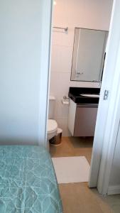 a bathroom with a toilet and a sink at Ponta Negra RN01 in Natal