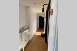 Habitación con pasillo con lavabo y espejo. en Appartement…LH center / 6 pers. parking privé en Le Havre