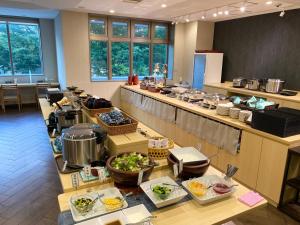 a kitchen with a buffet of food on a table at Y's HOTEL Hanshin Amagasaki Ekimae in Amagasaki