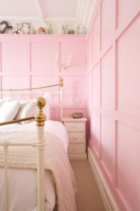 a bedroom with a bed and a dresser at The Beach House in Milford on Sea