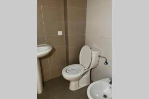 a bathroom with a toilet and a sink at APTO LOS MOLINOS LUCENA DEL CID Bajo C REF 048 in Lucena del Cid +25 photos