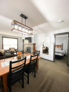 a dining room and living room with a table and chairs at UPPER VILLAGE - 2BD condo steps to Main Pools and Hill in Panorama