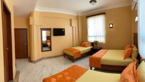 Postel nebo postele na pokoji v ubytování Hostal California Inn