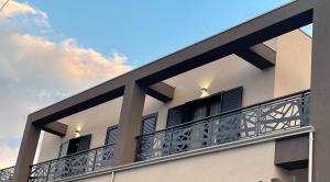 a building with a balcony with a blue sky at ALMA Bed & Breakfast in San Marco Argentano