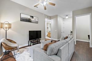 a living room with a couch and a tv at Corporate rental unit City Centre, Energy Corridor in Houston