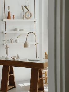 a desk in a room with white shelves at Hospedería Boutique Albariza by La Judería De Vejer- ADULTS ONLY in Vejer de la Frontera