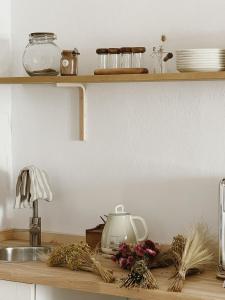 a kitchen counter with a sink and a counter top with dishes at Hospedería Boutique Albariza by La Judería De Vejer- ADULTS ONLY in Vejer de la Frontera