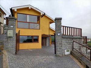 a yellow house with a staircase in front of it at Casa Amarela da Caniçada in Vieira do Minho