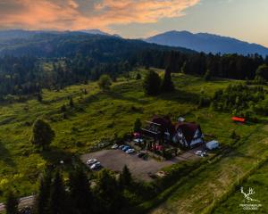 an aerial view of a house on a hill with cars at Pensiunea LIN COTA 1000 in Sinaia