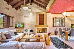 ein Wohnzimmer mit Möbeln und einem Kamin in der Unterkunft Aktis luxury villa in Chania