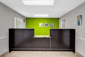 a room with a green wall and two doors at Studio 6 Extended Stay - Atlanta, GA - Chamblee in Atlanta +26 photos