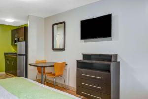 a room with a bed and a table and a tv at Studio 6 Extended Stay - Atlanta, GA - Chamblee in Atlanta