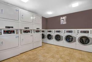 a row of washing machines in a laundry room at Studio 6 Extended Stay - Atlanta, GA - Chamblee in Atlanta