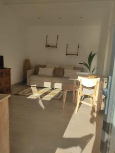 a living room with a bed and a table and chairs at Villa Vista in Sesimbra