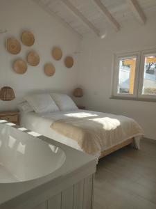 a white bedroom with a bed and a sink at Villa Vista in Sesimbra