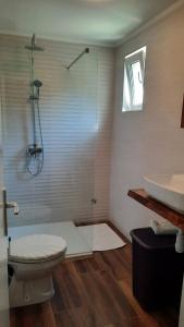 a bathroom with a shower and a toilet and a sink at Apartment Pavilion-beautiful garden in Kampor