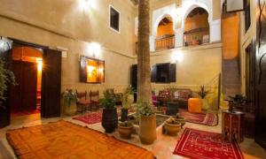 a large living room filled with lots of rugs at Riad Benyara in Taroudant