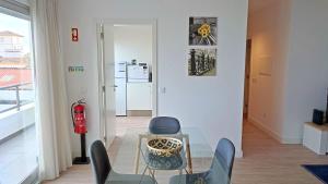 a living room with a glass table and chairs at Atlantic Town 2 - Free Parking in Ponta Delgada
