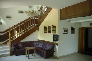 a living room with a couch and a staircase at Hotel Širák in Most