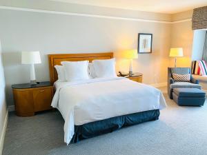 a hotel room with a large bed and a chair at Private condo hotel at Four Seasons Brickell in Miami