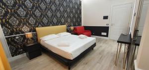 a bedroom with a bed and a red chair at Rome Aparts in Rome