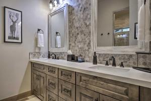 a bathroom with a sink and a mirror at Stylish Home with Expansive Deck in Show Low! in Show Low +30 photos
