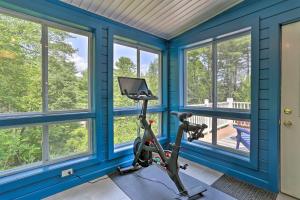 a house with a gym with blue walls and windows at Updated Family Home about 1 Mile to Delaware River! in Narrowsburg