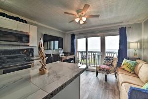 a living room with a couch and a ceiling fan at Oceanfront Corpus Christi Escape with Community Pool in Corpus Christi