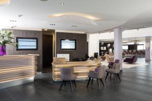 an office lobby with a desk and chairs at Thalazur Antibes - Résidence & Spa in Antibes