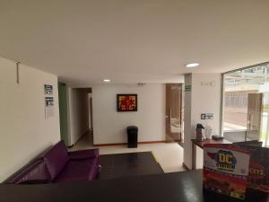 a living room with a purple couch in a room at Embassy On Holidays in Bogotá