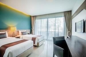 Postel nebo postele na pokoji v ubytování The Pago Design Hotel Phuket-SHA Plus