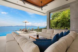 a living room with a couch and a view of the ocean at Villa Blue View in Mae Nam