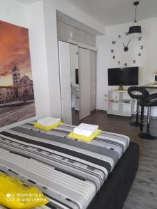 a bed in a room with a clock on the wall at Cvita & Maja in Zadar