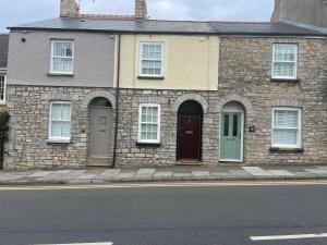 a brick house with two doors on a street at 17 Eastgate in Cowbridge