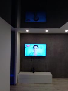 a flat screen tv on a wall in a room at Słoneczne Planty in Zamość