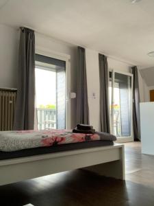 a bedroom with a bed and a large window at Vina am ring Apartment in Mannebach