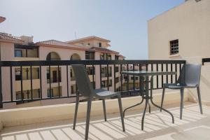 two chairs and a table on a balcony at One bedroom apartment in Paphos in good location in Paphos