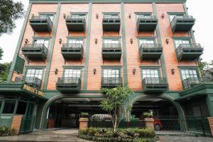a red brick building with balconies on it at Nonies Huis Cibubur in Kalimanggis