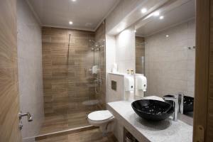 a bathroom with a sink and a toilet and a shower at Avenue Hotel Deluxe in Burgas
