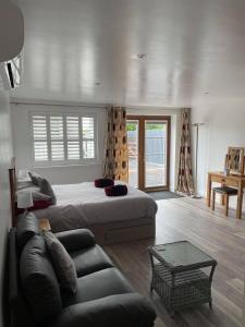 a large bedroom with a bed and a couch at 43 annexe in Newquay