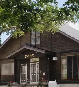 a wooden house with the on it at Guest house Maroudo in Iiyama