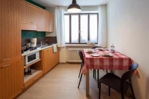 a kitchen with a table with a table cloth on it at Il Fauno in Asiago