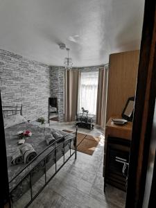 a bedroom with a bed and a brick wall at Palaz 3 - 1 Bedroom Flat-Apartment in Edmonton