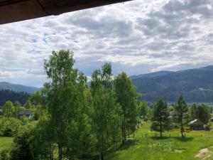 a view of a field with trees and mountains at Вілла Зозуля in Mykulychyn +15 photos