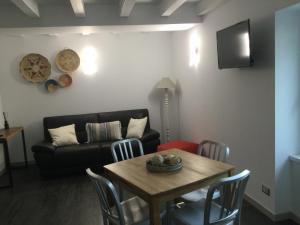 a living room with a table and a couch at Casa vacanza 1 in Serina