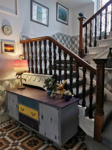 a living room with a staircase and a table with a lamp at Lansdowne Simply Stay in Redruth