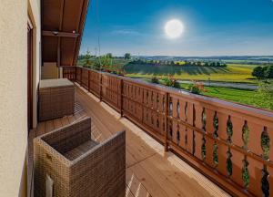 a balcony with a view of a field of flowers at Landhotel Kirchberg in Kirchberg an der Jagst