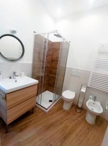 a bathroom with a shower and a toilet and a sink at Skyline #Downtown in Civitavecchia