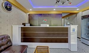 a lobby with a reception desk with a chair at Itsy By Treebo - Palm Emirates in Bangalore