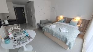 a bedroom with a large bed and a table at Lividus 432 By Edyta in Świnoujście